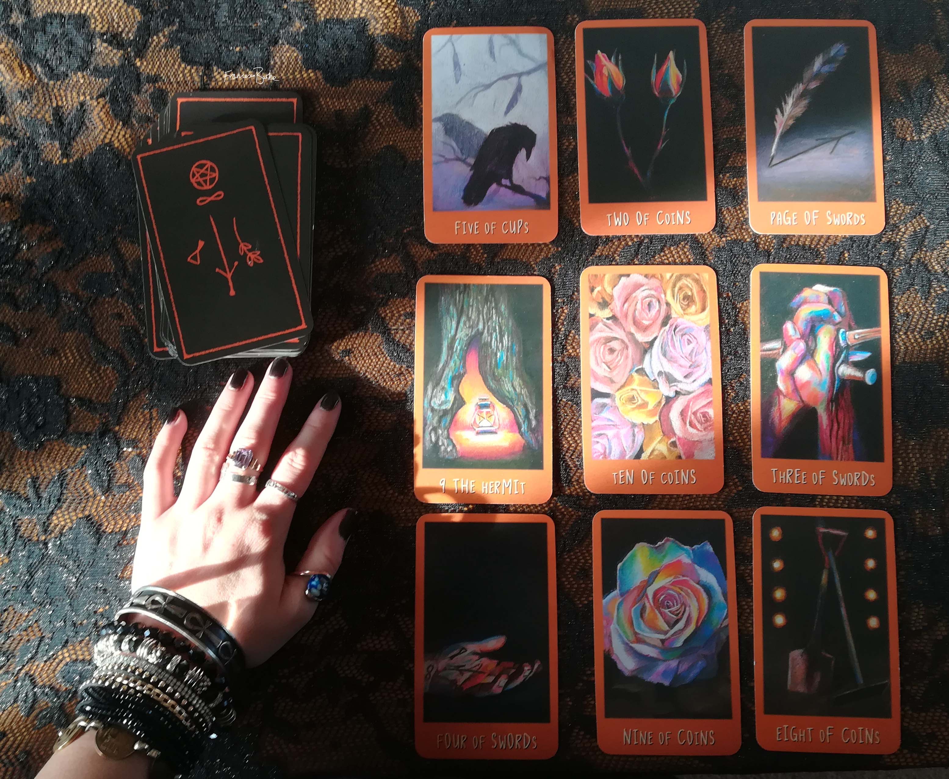 9 Raven's Prophecy tarot cards with a hand