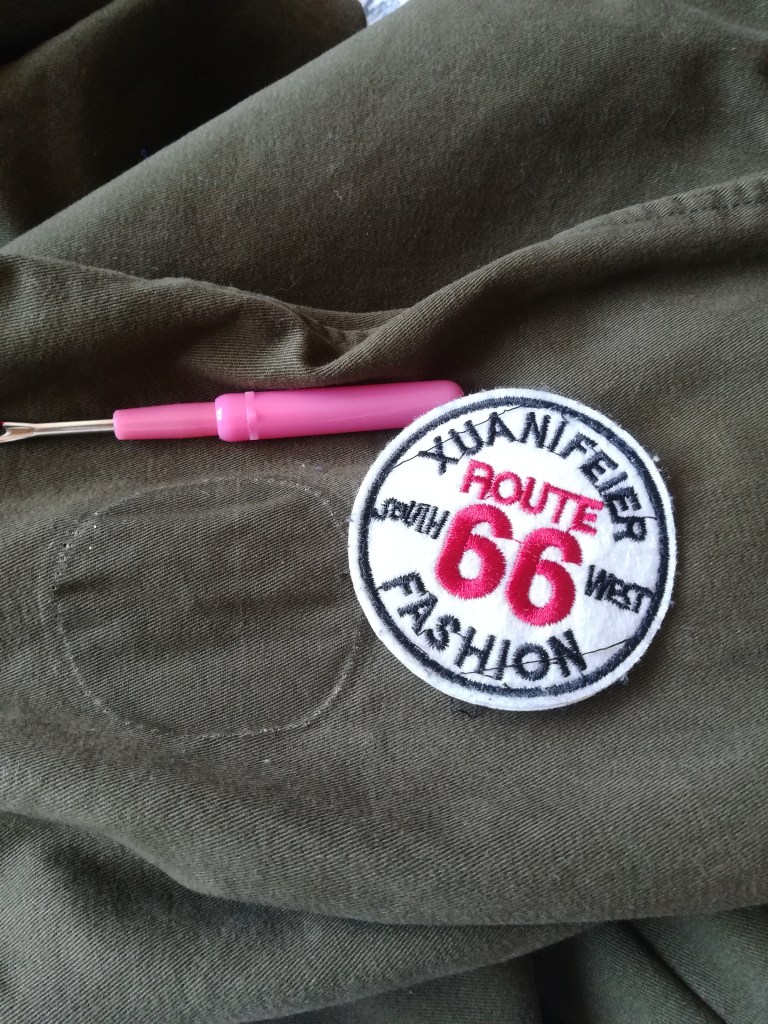 green jacket with unpicked Route 66 patch and unpicker