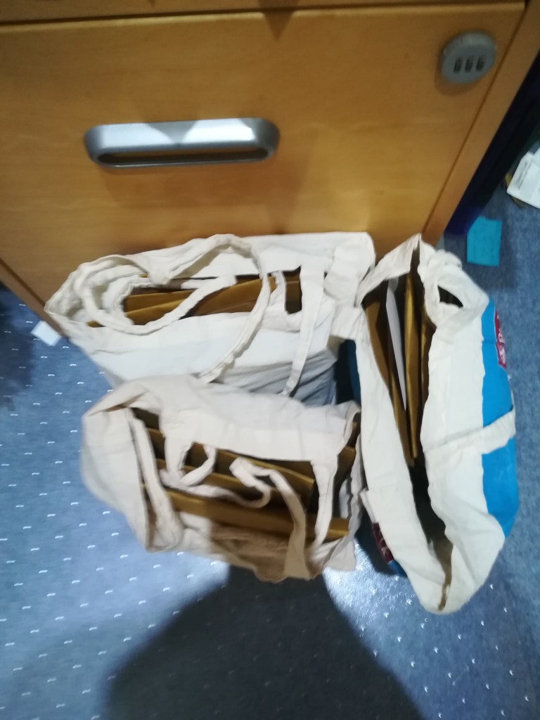 three tote bags full of envelopes