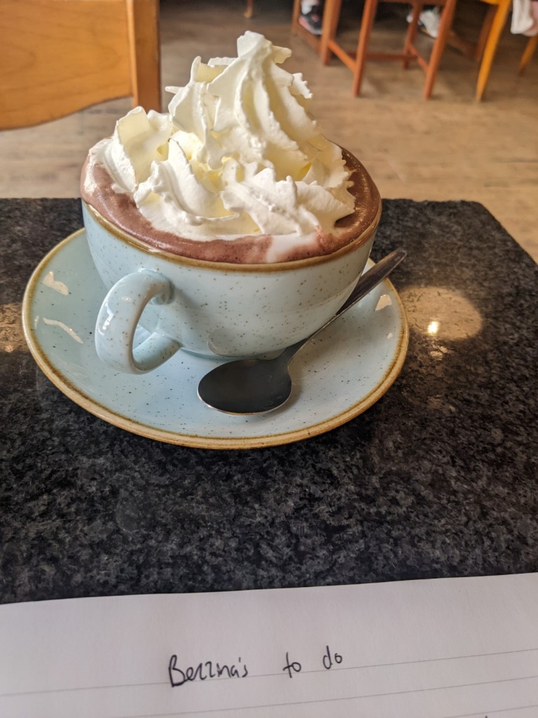 hot chocolate at Utopia in Southend along with a note page reading 'Bezzina's to do'